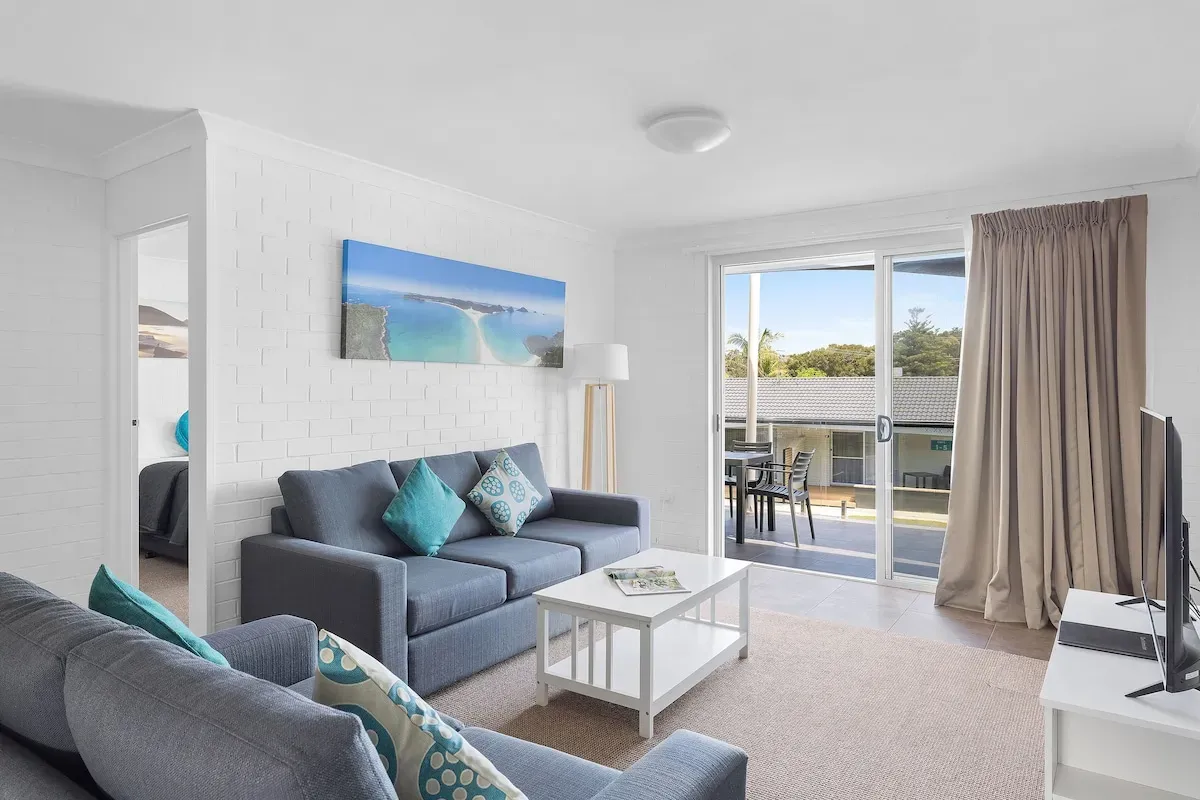 Apartment living room with a balcony at Seaside Holiday Resort Fingal Bay