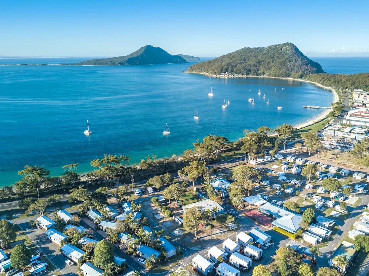 Shoal Bay Holiday Park beside the beach, seen from above
